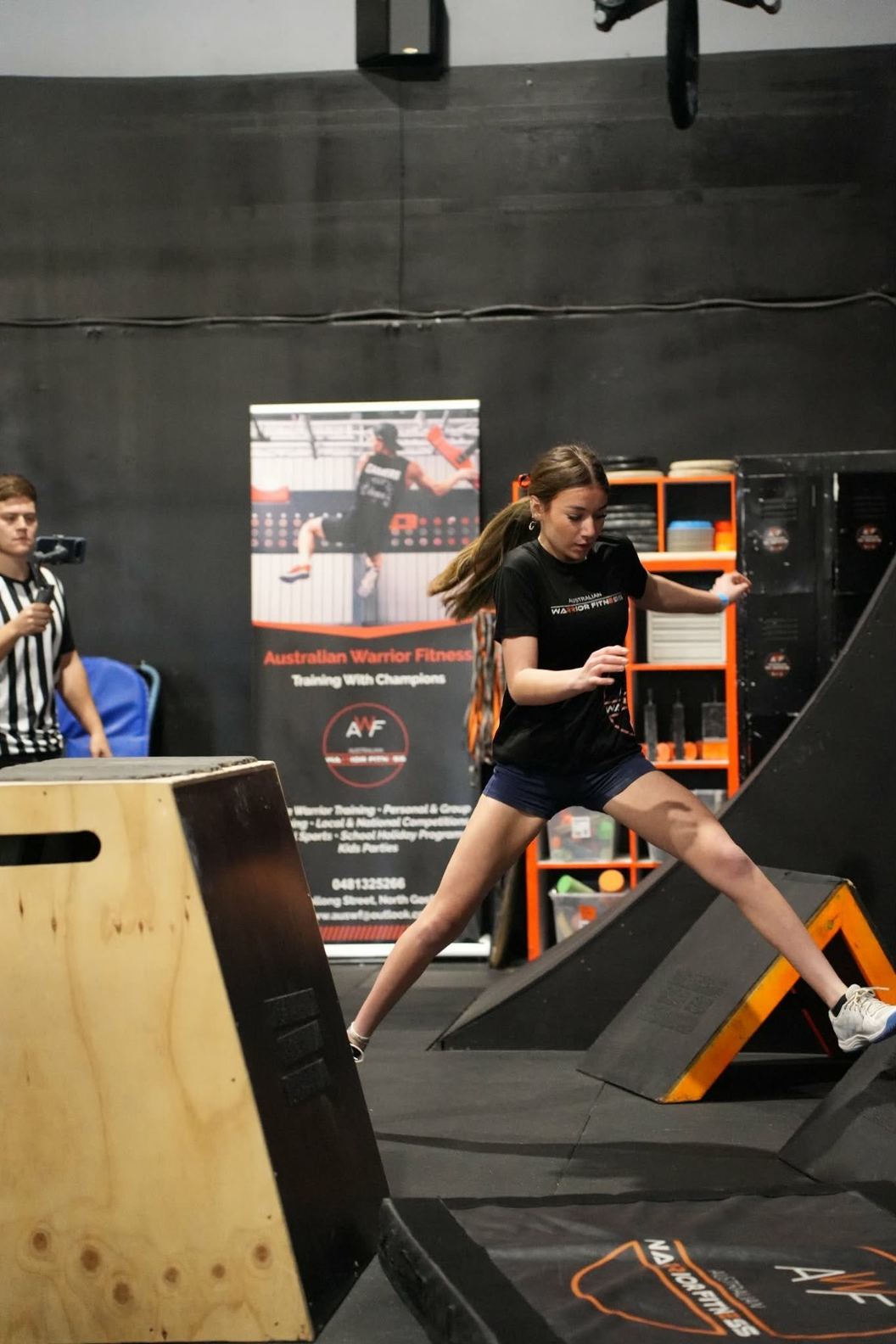 Girl stepping across the angled step obstacles at AWF Ninja
