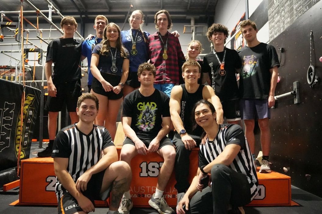 Group of ninja athletes wearing medals on the AWF competition podium