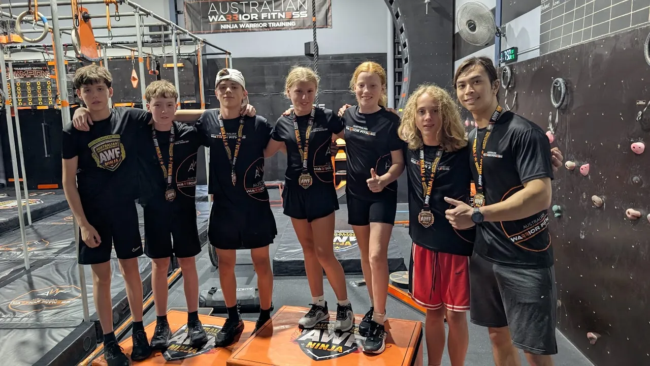 AWF ninjas and coach wearing their AWF medals